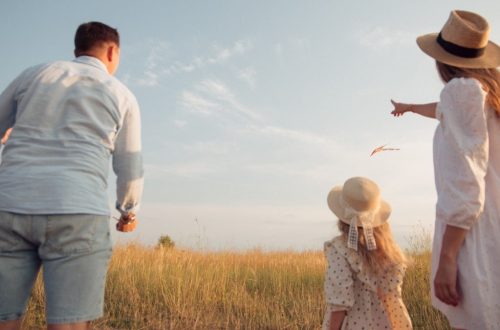 man in white dress shirt and woman in brown dress standing on green grass field during